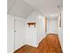 Hallway with wood floors, storage closets, and decorative shelving at 2028 Old Latter Rd, Newton, NC 28658