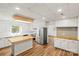 Spacious kitchen features stainless steel appliances, white cabinets, and wood-look flooring at 2028 Old Latter Rd, Newton, NC 28658