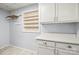 Laundry room with white cabinets and a window at 2028 Old Latter Rd, Newton, NC 28658