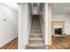 Carpeted stairway leading to upper level with wooden handrail at 2028 Old Latter Rd, Newton, NC 28658
