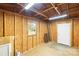 Interior view of a plywood workshop with a window and white door at 2028 Old Latter Rd, Newton, NC 28658