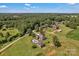 An aerial view showcases a home with an in-ground pool, and long private drive at 2145 Jack Wilson Rd, Shelby, NC 28150