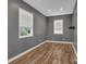 Clean bedroom featuring wood floors, neutral gray walls, recessed lighting, and plenty of natural light at 2145 Jack Wilson Rd, Shelby, NC 28150