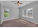 Cozy bedroom with carpet flooring, neutral walls, and large windows offering natural light at 2145 Jack Wilson Rd, Shelby, NC 28150
