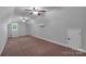 Spacious bonus room with carpet floors, dual ceiling fans, natural light, and access door at 2145 Jack Wilson Rd, Shelby, NC 28150