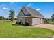Garage exterior with brick and stone accents and a well-manicured lawn at 2145 Jack Wilson Rd, Shelby, NC 28150