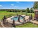 In-ground pool and hot tub with slide, set amidst a sprawling green lawn at 2145 Jack Wilson Rd, Shelby, NC 28150