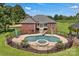 Aerial view of a stunning backyard pool featuring a slide and spa, surrounded by a secure fence and lush greenery at 2145 Jack Wilson Rd, Shelby, NC 28150