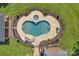 Aerial view of a fenced in-ground pool featuring a slide, hot tub, and stone patio at 2145 Jack Wilson Rd, Shelby, NC 28150