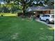Spacious backyard featuring large tree and covered carport area at 2261 Felly Ln, Lancaster, SC 29720