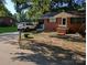 Charming brick home with a covered carport, front porch swing, and mature trees in a tranquil setting at 2261 Felly Ln, Lancaster, SC 29720