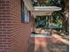 Inviting front porch showcasing a swing, brick accents, and covered space for relaxing outdoor enjoyment at 2261 Felly Ln, Lancaster, SC 29720