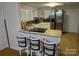 Eat-in kitchen featuring stainless steel appliances, a breakfast bar with stools, and ample natural light at 2261 Felly Ln, Lancaster, SC 29720