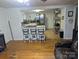 Open living space with hardwood floors and an eat-in kitchen island featuring chairs and a view into the kitchen at 2261 Felly Ln, Lancaster, SC 29720