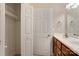 Bathroom with closet area, wood cabinets, and bright lighting at 2785 Clover Nw Rd, Concord, NC 28027