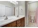 Bathroom featuring double sinks, wood cabinets, and tile flooring for a clean and functional design at 2785 Clover Nw Rd, Concord, NC 28027