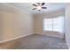 Neutral bedroom features carpet, ceiling fan, and window, creating a bright and airy space at 2785 Clover Nw Rd, Concord, NC 28027
