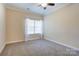 Neutral bedroom features carpet, ceiling fan, and window, creating a bright and airy space at 2785 Clover Nw Rd, Concord, NC 28027