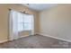 Cozy bedroom with neutral carpet, natural light, and a window with blinds at 2785 Clover Nw Rd, Concord, NC 28027