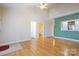 Open-concept living room with hardwood floors and access to other rooms at 2785 Clover Nw Rd, Concord, NC 28027