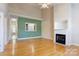 Bright living room with hardwood floors, fireplace, and pass-through to kitchen at 2785 Clover Nw Rd, Concord, NC 28027