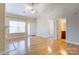 Spacious living room with hardwood floors, a ceiling fan, and a fireplace at 2785 Clover Nw Rd, Concord, NC 28027