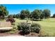 Picturesque backyard featuring lush landscaping, a fountain, and serene views of the golf course at 406 Spyglass Hill Pl, Salisbury, NC 28144