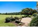 Scenic backyard with mature trees, manicured landscaping, and views of the golf course at 406 Spyglass Hill Pl, Salisbury, NC 28144