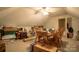 This bonus room offers ample space for storage and hobbies with a wooden table and chairs at 406 Spyglass Hill Pl, Salisbury, NC 28144