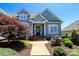 Inviting front entrance with elegant pillars, beautiful landscaping, and well-maintained walkway at 406 Spyglass Hill Pl, Salisbury, NC 28144