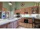Well-lit kitchen with custom cabinets, tile floors, white countertops, and stainless steel appliances at 406 Spyglass Hill Pl, Salisbury, NC 28144