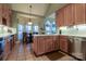 Spacious kitchen featuring custom cabinets, an island with a sink, and stainless steel appliances at 406 Spyglass Hill Pl, Salisbury, NC 28144
