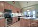 Well-equipped kitchen with custom cabinets, stainless steel appliances, and an eat-in breakfast nook at 406 Spyglass Hill Pl, Salisbury, NC 28144