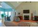 Cozy living room featuring a fireplace, hardwood floors and a vaulted ceiling with modern fixtures at 406 Spyglass Hill Pl, Salisbury, NC 28144