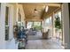 Inviting screened porch with comfortable seating, potting table, and serene golf course views at 406 Spyglass Hill Pl, Salisbury, NC 28144