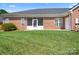 Rear view of a brick house with a screened-in porch and lawn at 407 Knops Nob Rd, Mooresville, NC 28115