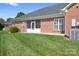 Back exterior of brick home with screened-in porch at 407 Knops Nob Rd, Mooresville, NC 28115