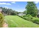 Spacious backyard featuring lush lawn and mature trees at 407 Knops Nob Rd, Mooresville, NC 28115