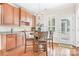 Eat in kitchen featuring a breakfast nook with wood table, hardwood floors, and lots of natural light at 407 Knops Nob Rd, Mooresville, NC 28115
