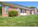 Back exterior view of brick house with a screened in porch and well-kept lawn at 407 Knops Nob Rd, Mooresville, NC 28115