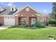 Charming brick home with well-manicured lawn and inviting front porch entrance with nice landscaping at 407 Knops Nob Rd, Mooresville, NC 28115