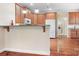 A kitchen with wood cabinets and white appliances adjacent to the laundry room at 407 Knops Nob Rd, Mooresville, NC 28115