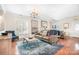 Spacious living room with hardwood floors, comfortable seating, chandelier and abundant natural light at 407 Knops Nob Rd, Mooresville, NC 28115
