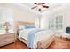 Bright main bedroom featuring a tray ceiling, wood floors, shutters, and a comfortable king-size bed at 407 Knops Nob Rd, Mooresville, NC 28115