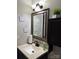 Bathroom vanity with granite countertops, framed mirror, and decor at 4204 Canipe Dr, Charlotte, NC 28269