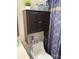 Toilet with mounted storage cabinet and decorative shower curtain at 4204 Canipe Dr, Charlotte, NC 28269
