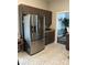 Bright kitchen with stainless steel refrigerator, warm brown cabinetry and patterned flooring at 4204 Canipe Dr, Charlotte, NC 28269