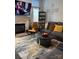 Comfortable living room featuring a plush gray sectional, modern coffee table, and a cozy fireplace at 4204 Canipe Dr, Charlotte, NC 28269