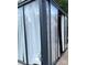 Stylish outdoor enclosure with sliding glass doors and white curtains for privacy and shade at 4204 Canipe Dr, Charlotte, NC 28269