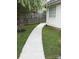 Backyard concrete walkway leading to wooden fence at 4204 Canipe Dr, Charlotte, NC 28269